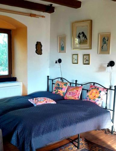 a bedroom with a bed with blue sheets and pillows at Statek Vojtěšín in Vojtěšín
