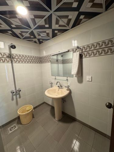 a bathroom with a sink and a mirror at Capresso Homes 4 in Islamabad