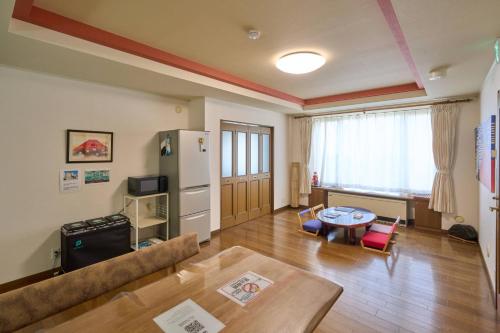 a living room with a couch and a table at Sapporo Vacation Home B&B in Sapporo