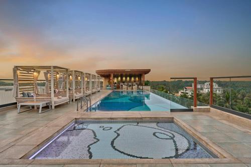 a pool on the roof of a building at Renaissance Goa Hotel in Goa