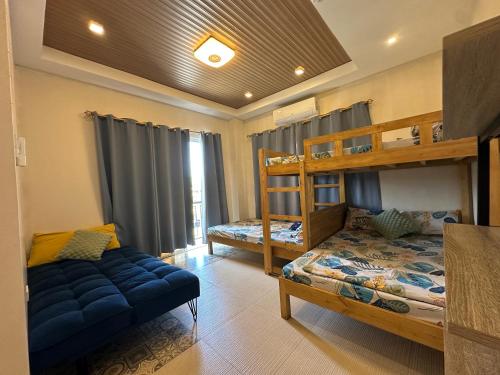a bedroom with two bunk beds and a couch at Villas Transient Inn in San Juan
