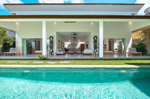 a house with a swimming pool in front of a house at Bingin Villas Luxury, Concierge and Security in Uluwatu