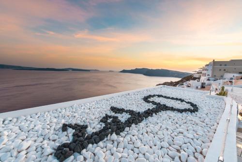 a large rock pool with a number in the middle at Santorini Secret Suites & Spa, Small Luxury Hotels of the World in Oia