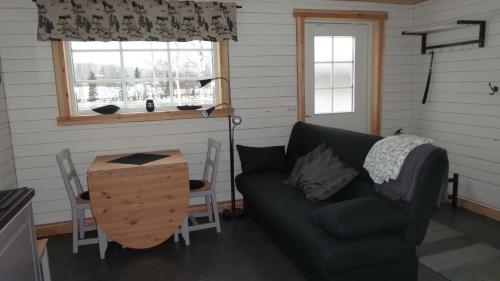 a living room with a couch and a table at Sörmarks Camping in Sörmark