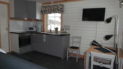 a kitchen with a sink and a counter top at Sörmarks Camping in Sörmark