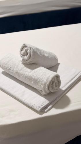a couple of towels sitting on top of a table at MEIMAN hotel in Aktobe