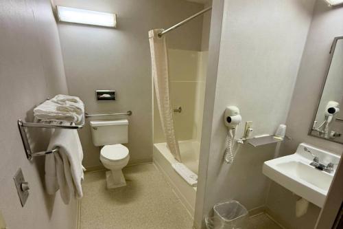 a bathroom with a toilet and a sink and a shower at CenterWay Hotel Buffalo North Near University in Tonawanda