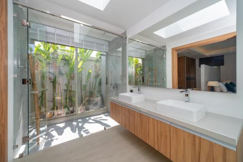 a bathroom with two sinks and a large mirror at Wila villas Phuket Free Airoport Pick up from 7 days in Phuket