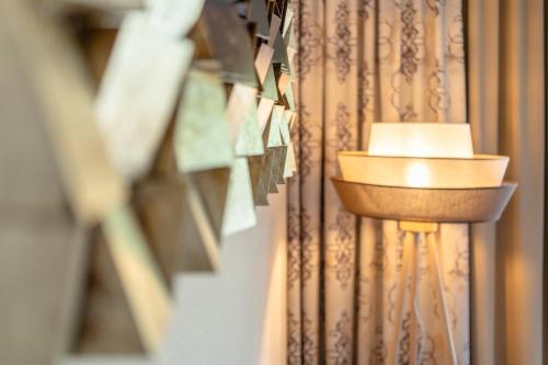 a lamp in a room with a curtain at Kolmhof in Bad Kleinkirchheim
