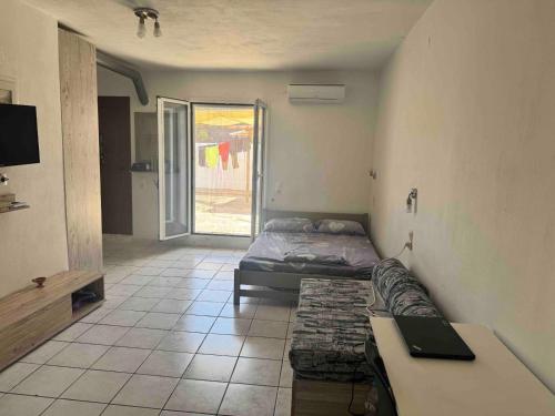 a room with two beds and a table in it at Waves of Millos in Skopelos Town