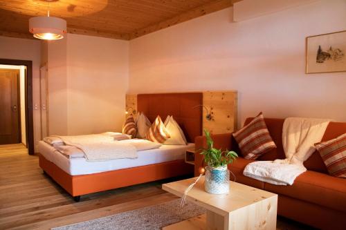a living room with a bed and a couch at Kolmhof in Bad Kleinkirchheim