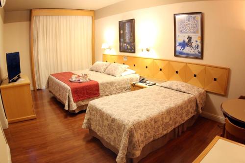 Ένα ή περισσότερα κρεβάτια σε δωμάτιο στο Village Hotel