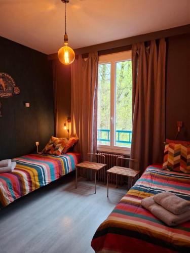 a bedroom with two beds and a window at Chez Mikki in Cassaniouze