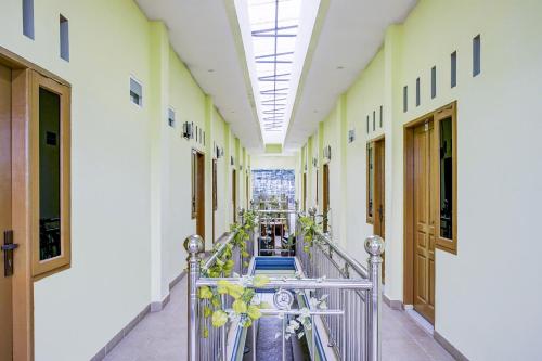 an empty hallway of a building with a metal railing at Hotel O Balige City Near Tugu Juara Monang in Balige