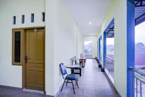 a balcony with chairs and a table on a building at Hotel O Balige City Near Tugu Juara Monang in Balige
