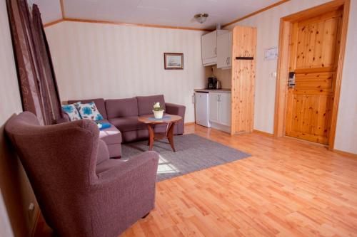 a living room with a couch and a table at Grimstad Vertshus in Grimstad