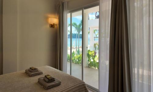 a bedroom with a bed with a view of the ocean at Binucot Pearl Boutique Resort in Ferrol
