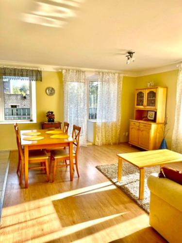 a living room with a table and a dining room at Vormsi ohvitseride maja korter nr 7 in Hullo