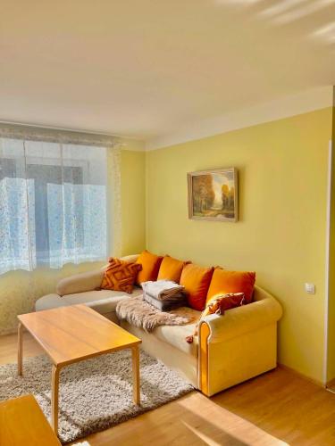 a living room with a couch and a table at Vormsi ohvitseride maja korter nr 7 in Hullo