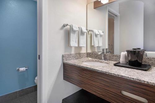 a bathroom with a sink and a mirror at Sleep Inn Garner - Clayton in Edmondson