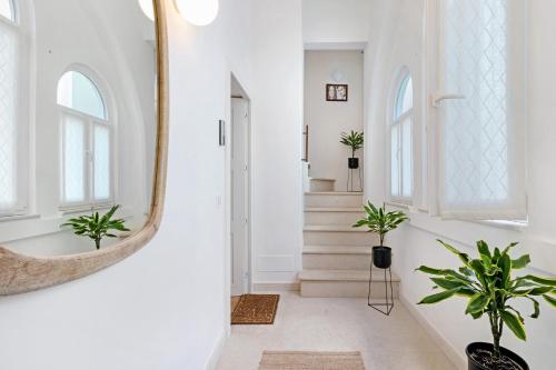 a hallway with a mirror and potted plants at Terrazza del Pittore in Gioia del Colle