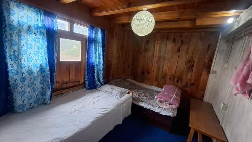 a small room with a bed and a window at Mount Mahabharat Homestay in Panaoti