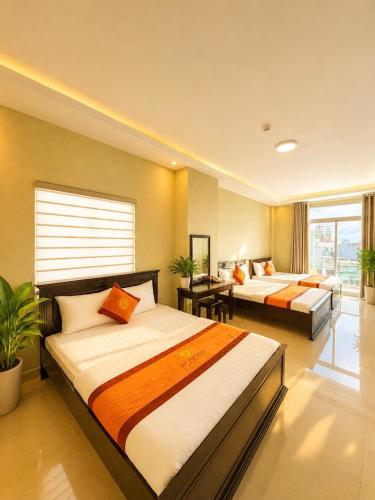 a hotel room with two beds in a room at Nét Việt House Hotel Market & Bridge Centre Soc Trang in Soc Trang