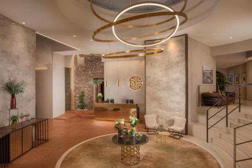 a large lobby with a large chandelier at NH Collection Palazzo Verona in Verona