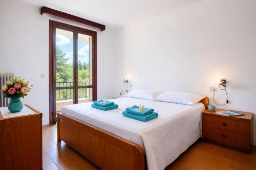a bedroom with a bed with two towels on it at Baja Sardinia Sea View And Pool B in Baja Sardinia