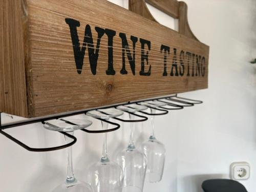 a bunch of wine glasses hanging on a wall at Appartement am Peterstor in Montabaur