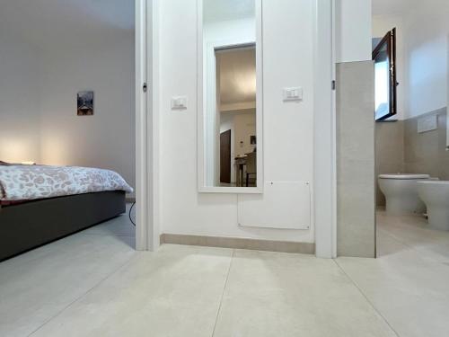 a bedroom with a bed and a sink and a mirror at Grazioso Bilocale della Rosa a Cadorago in Fino Mornasco