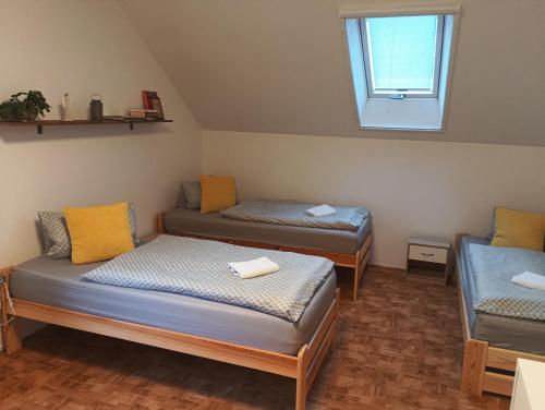 a room with two beds and a window at Ubytování Iris in Dolany