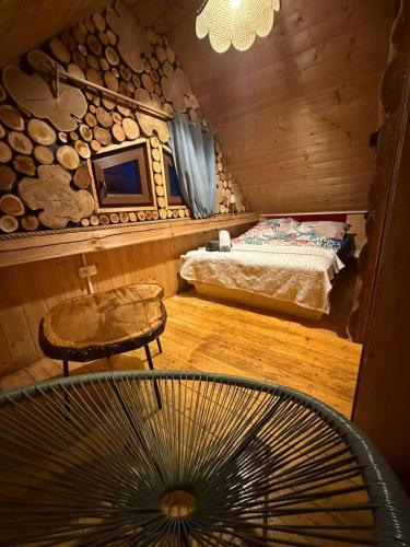 a bedroom with a bed and a table and a chair at Pod Milanem in Przemyśl