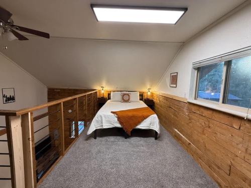 a bedroom with a bed and a large window at Little Dry Cabin #3 in Fairbanks
