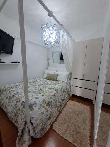 a bedroom with a bed and a chandelier at Lovehome Apartment in Lisbon