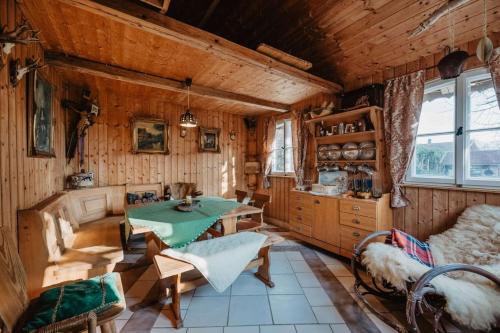 a kitchen with a table and chairs in a room at Ferienwohnung Altes Zollhaus in Ering