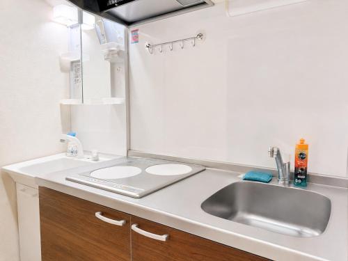 a bathroom with a sink and a mirror at KANAU in Tokyo