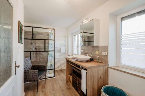 a bathroom with a sink and a mirror at Ferienwohnung Altes Zollhaus in Ering