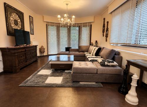 a living room with a couch and a coffee table at Peaceful Retreat - Kefalos Stay with Patio views & gym in Kefalos