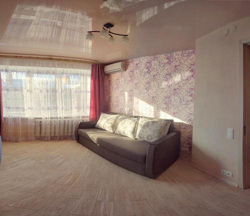 a living room with a couch and a window at Luxury 2 Rooms Apartments in Center by Green House in Poltava
