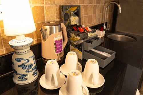 a table with cups and a lamp on a counter at Maison Julie Duong in Hanoi