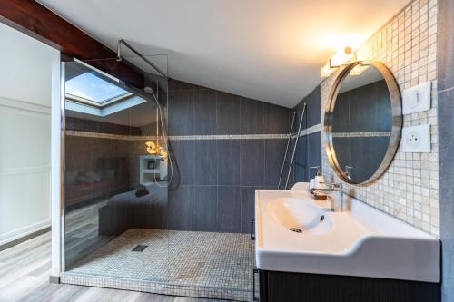 a bathroom with a sink and a mirror at Le Loft - Château Le Noble in Saint-Germain-du-Puch