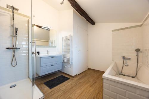 a bathroom with a shower and a sink and a tub at La Ferme - Château Le Noble in Saint-Germain-du-Puch