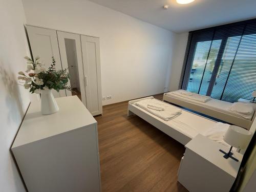 a white room with a bed and a window at Ferienwohnungen in Borkheide in Borkheide