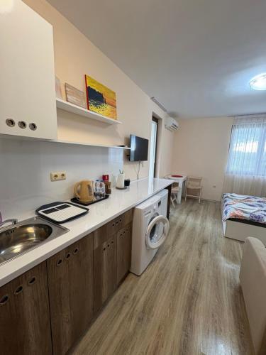 a kitchen with a sink and a washing machine at Равда Аполон 9 in Nesebar