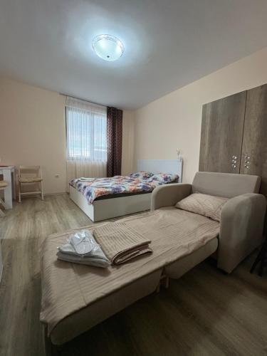 a room with two beds and a table in it at Равда Аполон 9 in Nesebar