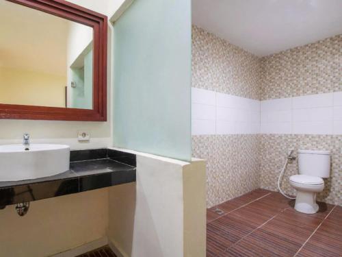 a bathroom with a sink and a toilet at Guntur Hotel Bali in Ketewel