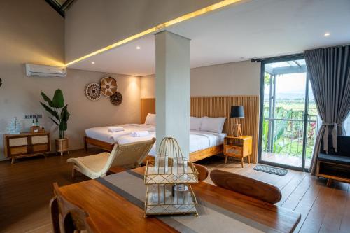 a hotel room with a bedroom with a bed and a television at Tuju Villa Hamparan Syariah in Ciledug