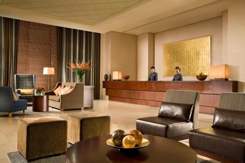 a lobby of a hotel with a table and chairs at Somerset Palace Seoul in Seoul