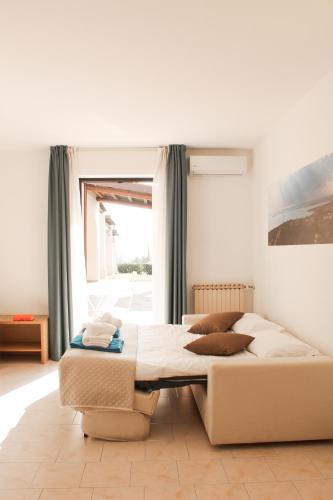 a bedroom with a large bed and a window at Moniga Resort in Moniga